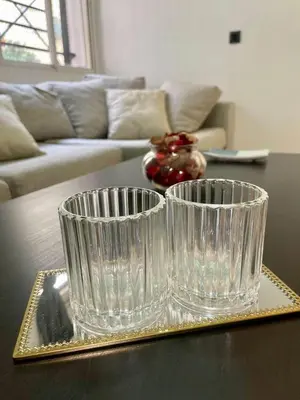 two clear glass vases sitting on top of a table at Le bon coin in Casablanca