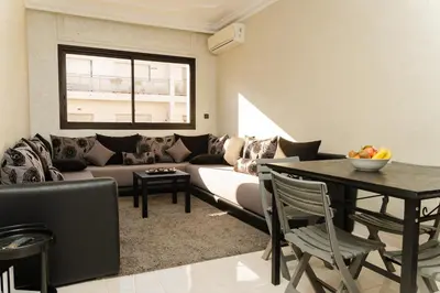a living room with a couch and a table at Large 2 bedroom apartment in prime location - 2 Balconies & private Parking in Rabat