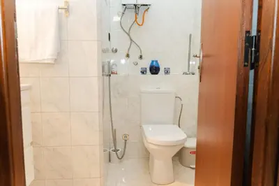 a bathroom with a toilet and a shower at Large 2 bedroom apartment in prime location - 2 Balconies & private Parking in Rabat