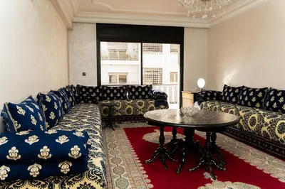 a living room with a couch and a table at Large 2 bedroom apartment in prime location - 2 Balconies & private Parking in Rabat