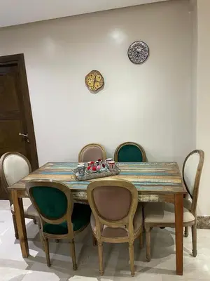 a dining room table with chairs and plates on the wall at Magnifique Appartement familial avec piscine in Mohammedia