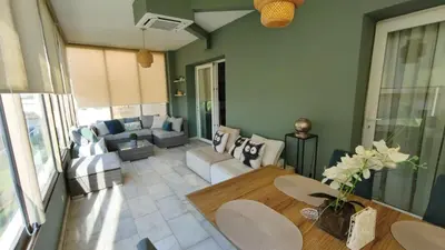 a living room with a couch and a table at Appartement Chaleureux à Bouznika- Plage Oued Cherrat - à 30min de Rabat 1chambre 2 salons in Sidi el Haj Bou Derbala