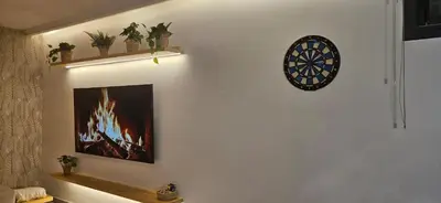 a room with a dart board on the wall at Green Nest, Loft with private garden-Free Parking- Fast WiFi- Netflix in Casablanca