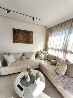 a living room with a couch and a table at Studio luxueux CFC in Casablanca
