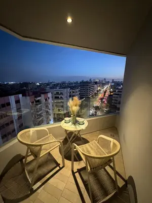 a balcony with a table and chairs and a large window at Studio luxueux CFC in Casablanca