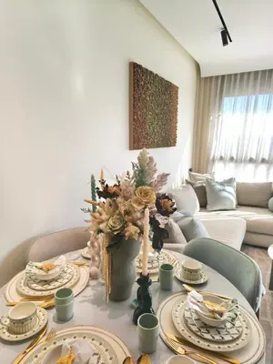 a living room with a table with plates of food at Studio luxueux CFC in Casablanca