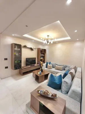 a large living room with a couch and tables at Luxueuse appartement centre ville TGV in Casablanca