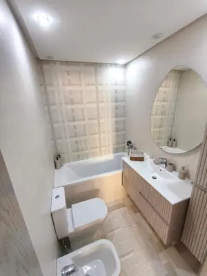 a bathroom with a toilet and a sink and a tub at Luxueuse appartement centre ville TGV in Casablanca