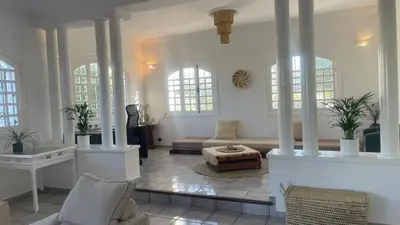 a living room with a couch and a table at Entire villa with sea view - Bouznika Plage David in Bouznika