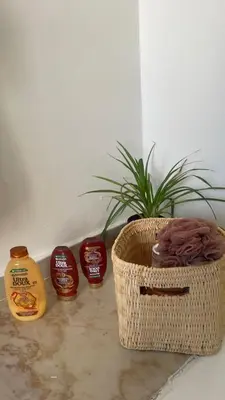 a plant in a basket next to a bottle of mustard at Entire villa with sea view - Bouznika Plage David in Bouznika
