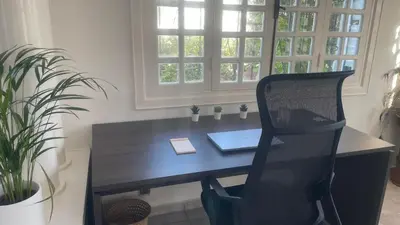 an office with a desk with a chair and a laptop at Entire villa with sea view - Bouznika Plage David in Bouznika