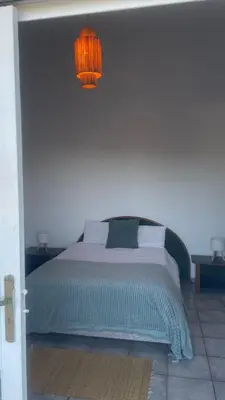 a bedroom with a bed with a light above it at Entire villa with sea view - Bouznika Plage David in Bouznika