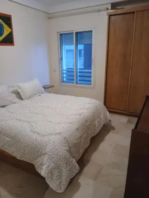 a white bedroom with a bed and a window at BK anfa in Casablanca