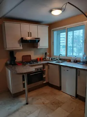 a kitchen with a sink and a stove top oven at BK anfa in Casablanca