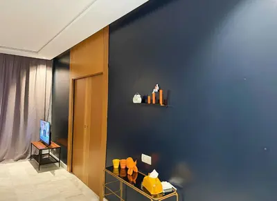 a room with a blue wall with a shelf on it at Maya Suites - B LIVING CFC in Casablanca