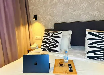 a laptop computer sitting on a bed with a tray at Maya Suites - B LIVING CFC in Casablanca