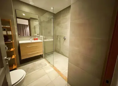 a bathroom with a shower and a toilet and a sink at Maya Suites - B LIVING CFC in Casablanca