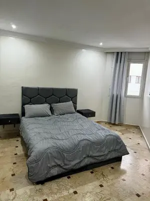 a bedroom with a large bed and a window at Charming Family Appartment in Rabat