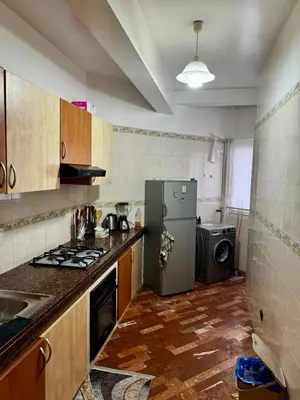 a kitchen with a refrigerator and a washing machine at Charming Family Appartment in Rabat
