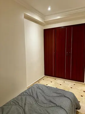 a bedroom with red cabinets and a bed at Charming Family Appartment in Rabat