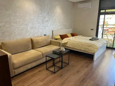 a living room with a couch and a bed at Studio Calme, Cosy & Équipé, Plein Centre Agdal in Rabat