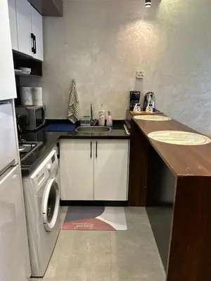 a kitchen with a sink and a washing machine at Studio Calme, Cosy & Équipé, Plein Centre Agdal in Rabat