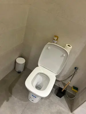 a bathroom with a white toilet in a stall at Studio Calme, Cosy & Équipé, Plein Centre Agdal in Rabat