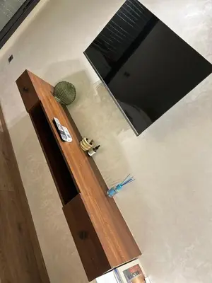 a room with a wooden door and a television at Studio Calme, Cosy & Équipé, Plein Centre Agdal in Rabat