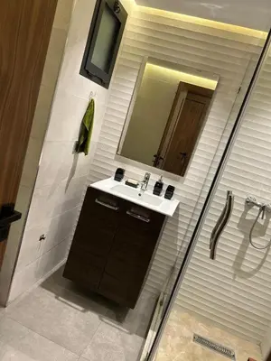 a bathroom with a sink and a mirror at Studio Calme, Cosy & Équipé, Plein Centre Agdal in Rabat