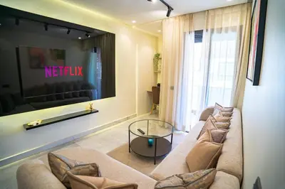 a living room with a couch and a tv at Downtown Private terrace in Casablanca