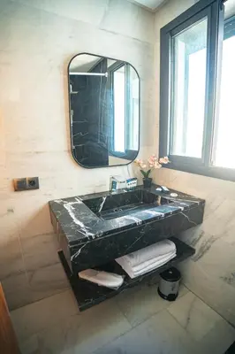 a bathroom with a black sink and a mirror at Downtown Private terrace in Casablanca