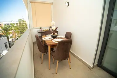 a dining room table and chairs on a balcony at Downtown Private terrace in Casablanca