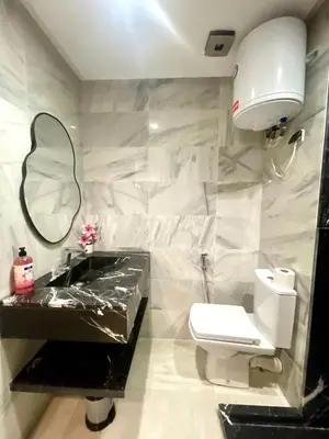 a bathroom with a sink and a toilet and a mirror at Stay Here In Casablanca Center in Oulad Akkou