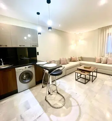 a living room with a couch and a table at Stay Here In Casablanca Center in Oulad Akkou