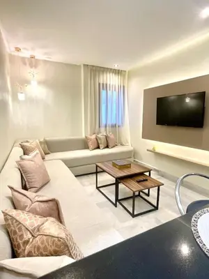 a living room with a couch and a tv at Stay Here In Casablanca Center in Oulad Akkou
