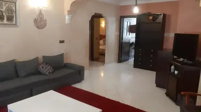 a living room with a couch and a tv at Appartement meublé à Casablanca in Casablanca