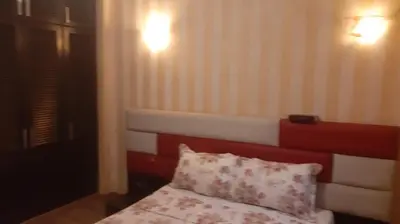 a bedroom with a bed with a red headboard and a pillow at Appartement meublé à Casablanca in Casablanca