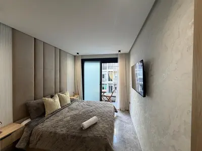 a bedroom with a bed and a tv on a wall at Premium Business Suite Heart of Casablanca in Casablanca