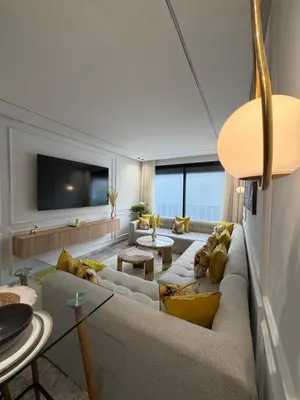 a living room with a large couch and yellow pillows at Premium Business Suite Heart of Casablanca in Casablanca