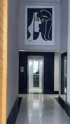 a hallway of a building with a picture of a bust at Résidence Picasso in Casablanca
