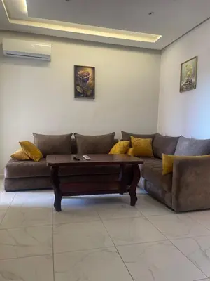 a living room with a couch and a coffee table at Résidence Picasso in Casablanca