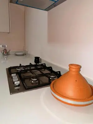 a kitchen counter with a stove top oven in a kitchen at Ain Diab , Luxury El amri in Casablanca