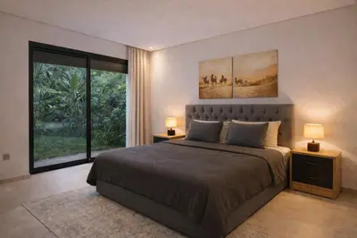 a bedroom with a large bed with two lamps at Ain Diab , Luxury El amri in Casablanca