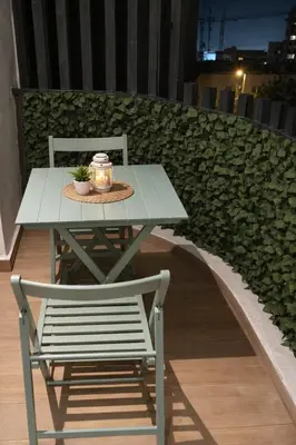 a table and a chair with a candle and a plant at EDEN Palmier in Casablanca