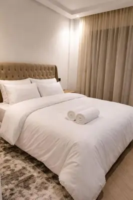 a large white bed with two towels on it at EDEN Palmier in Casablanca