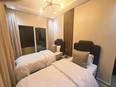 a hotel room with two beds and a mirror at Large luxurious apartment opposite to Hassan 2 Mosqu and FAIR international casablanca , near downtown prohibited arb unmarried couples, Free underground parking for buildings, 3 rooms, 2 bathroom, living room in Casablanca