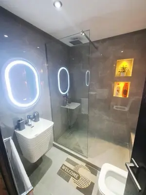 a bathroom with a shower and a sink and a toilet at Large luxurious apartment opposite to Hassan 2 Mosqu and FAIR international casablanca , near downtown prohibited arb unmarried couples, Free underground parking for buildings, 3 rooms, 2 bathroom, living room in Casablanca