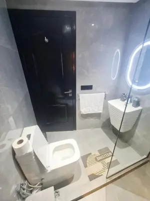 a bathroom with a toilet and a sink at Large luxurious apartment opposite to Hassan 2 Mosqu and FAIR international casablanca , near downtown prohibited arb unmarried couples, Free underground parking for buildings, 3 rooms, 2 bathroom, living room in Casablanca