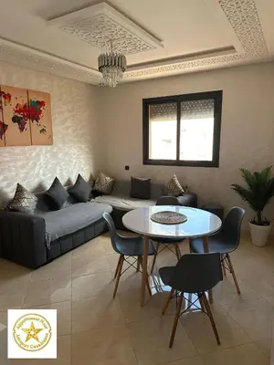 a living room with a couch and a table at Appartement noor aéroport casablanca in Deroua