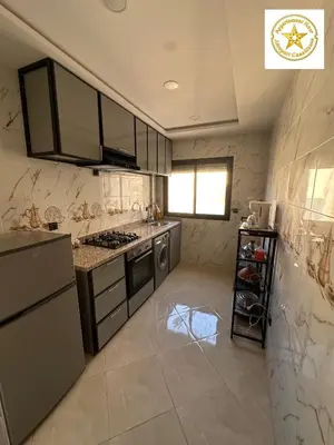 a kitchen with stainless steel appliances and marble walls at Appartement noor aéroport casablanca in Deroua